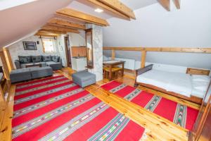 a living room with a bed and a couch at Guesthouse Sandra in Kolašin