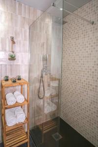 a bathroom with a shower with towels on a shelf at Ibanova Homes Casco Antiguo 2 in Valencia