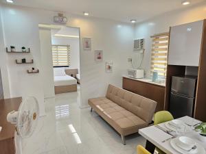 a living room and kitchen with a couch and a table at MGS Property in General Santos