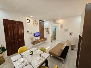 a dining room with a table and chairs and a living room at MGS Property in General Santos