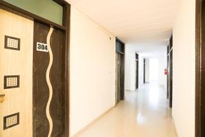 an empty hallway of an office building with a number on the wall at OYO Flagship 61722 Rajmahal Residency Hotel in Bhiwadi