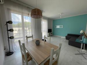 a living room with a wooden table and chairs at Lara's Apartment in Lido di Camaiore