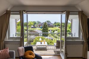 a view from the living room of a house with a large sliding glass door at Kapitänshaus Hamburg Altes Land in Hamburg