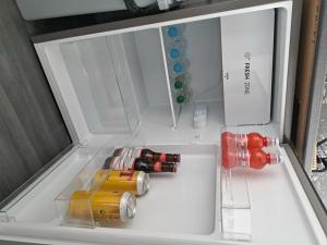 an open refrigerator with drinks inside of it at Charming 1-Bed Apartment in Troon in Troon