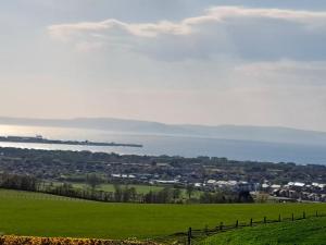 a green field with the ocean in the background at Charming 1-Bed Apartment in Troon in Troon