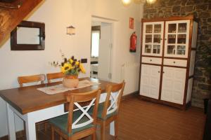 a kitchen with a table and chairs and a room with a door at Casa vacacional Escuela la Llera in Colunga +41 photos