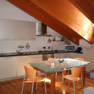 a kitchen with a table and chairs in a kitchen at La Bici Bianca in Imperia