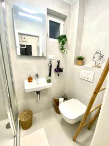 a bathroom with a toilet and a sink at BRAND NEW Design studio Emerald - old town A/C in Bratislava