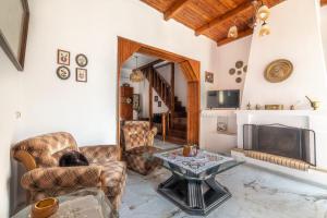 a living room with a table and a fireplace at Cretan Village Renovated House in Heraklio
