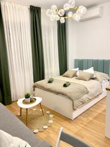 a bedroom with a bed and a chandelier at BRAND NEW Design studio Emerald - old town A/C in Bratislava