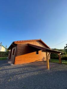 a small wooden building with a roof at Le Chalet Du Castor in Anould