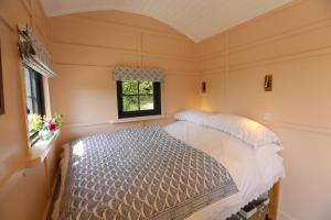 a bedroom with a bed in a room with a window at Lapin Cottage in Long Bredy