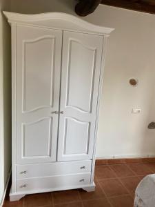 a white cabinet with two doors in a room at Apartamentos El Campo in Castropol
