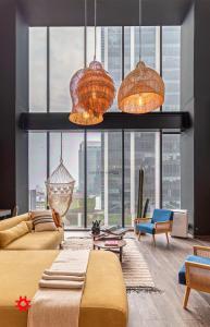 a living room with a couch and some lights at Casa Magenta by Kukun in Mexico City