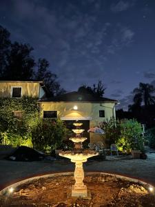 a fountain in front of a house at night at Vila Adega Maravilha in São Roque