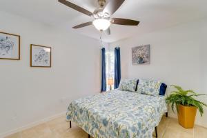 a bedroom with a bed and a ceiling fan at Riverfront Florida Retreat with Pool, Patio and Grill! in Port Charlotte +20 photos