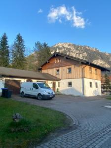 a white van parked in front of a building at Ferienwohnung Wanderlust in Ruhpolding