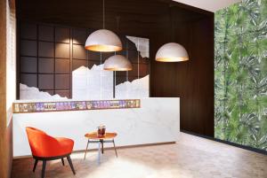 a lobby with a table and a chair and pendants at Swiss Chocolate by Fassbind Lausanne in Lausanne