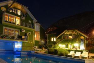 a house with a swimming pool in front of a house at Villa Hera in Băile Herculane