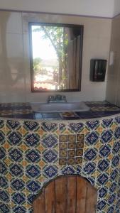 a bathroom with a tile counter with a sink at Shambhala Visión in Zipolite