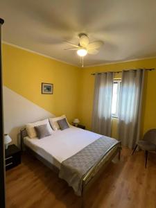 a bedroom with a bed and a ceiling fan at Apartment Nela in Brna