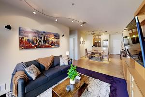 a living room with a couch and a dining room at Downtown Dreaming in Seattle