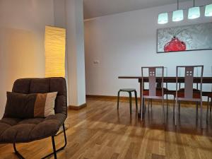 a living room with a dining room table and chairs at 13B01 Apartamento con terraza y garaje in Ribadesella