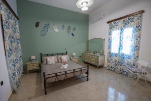 a bedroom with a bed and a dresser and a mirror at BunnyFoot: Country house of 135 sqm in Leros. in Panteli