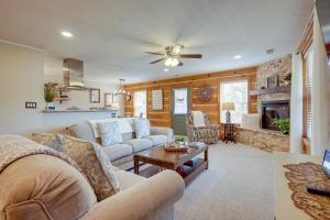 a living room with couches and a fireplace at Jemez Springs Cabin with Deck and Mountain Views! in Jemez Springs