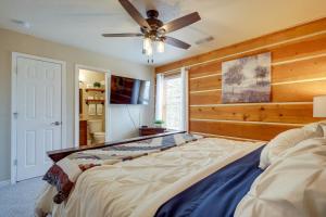 a bedroom with a large bed and a ceiling fan at Jemez Springs Cabin with Deck and Mountain Views! in Jemez Springs