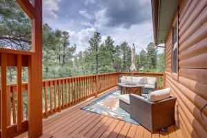 a patio with a table and chairs on a deck at Jemez Springs Cabin with Deck and Mountain Views! in Jemez Springs