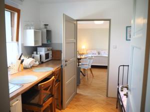 a kitchen with a table and a room with a bed at U Václava in Kněževes