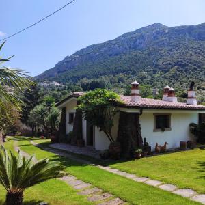 a house with a mountain in the background at Casa Bados in Dorgali