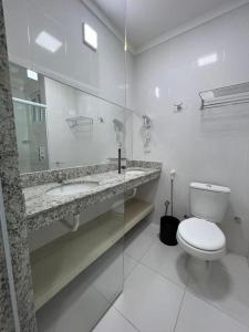 SPAZZIO DIROMA - ACQUA PARK في كالدس نوفاس: حمام ابيض مع مرحاض ومغسلة
