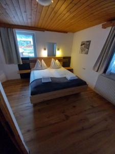 a bedroom with a bed in a room with a wooden ceiling at Haus Stille Oase in Bruck an der Großglocknerstraße
