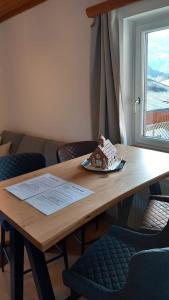 a wooden table with a plate of food on it at Haus Stille Oase in Bruck an der Großglocknerstraße +23 photos