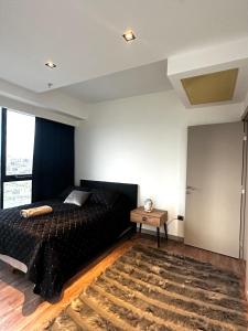 um quarto com uma cama preta e um tapete em Lüx&central em Istambul