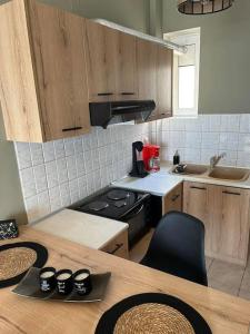 a kitchen with a wooden table and a counter top at Marina's Boutique in Alexandroupoli +10 photos