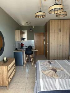 a kitchen with a bed and a table in a room at Marina's Boutique in Alexandroupoli