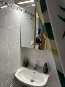 a bathroom with a sink and a mirror at Marina's Boutique in Alexandroupoli