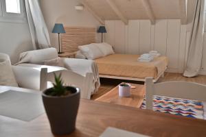 a small living room with a bed and a couch at Old Town Apartment in Corfu Town