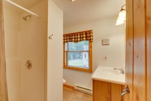 a bathroom with a sink and a window at Lake Champlain Vacation Rental with Boat Dock! in Melville Landing