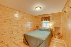 een slaapkamer met een bed in een houten kamer bij Lake Champlain Vacation Rental with Boat Dock! in Melville Landing