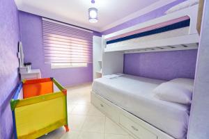 a purple bedroom with a bed and bunk beds at Apartment for rent with 2 bedrooms in Tangier