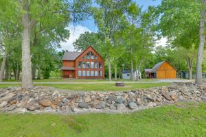 a barn with a stone wall in front of a house at Lake Champlain Vacation Rental with Boat Dock! in Melville Landing