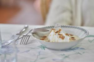 a bowl of ice cream with a spoon on a table at La Ferme D'Augustin in Saint-Tropez