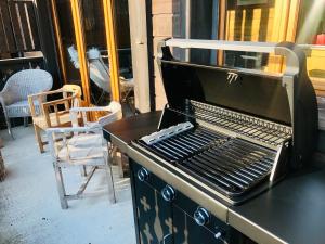 a grill sitting on a table with two chairs at Le Chalet de Nabor in Les Gets +47 photos