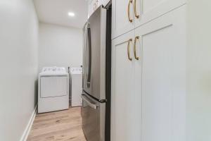 a kitchen with a stainless steel refrigerator and a stove at Central Lafayette location w/King Bed & Coffee Bar in Lafayette
