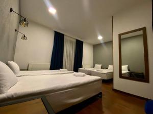 A bed or beds in a room at Sno Inn Kazbegi