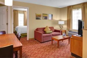 a hotel room with a couch and a bed at TownePlace Suites by Marriott Findlay in Findlay